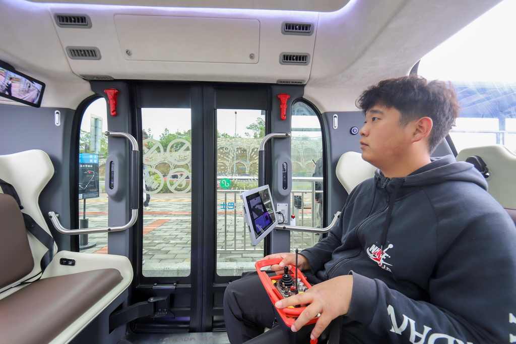 4月24日，安全員在調(diào)試無人駕駛公交車。新華社記者 劉續(xù) 攝