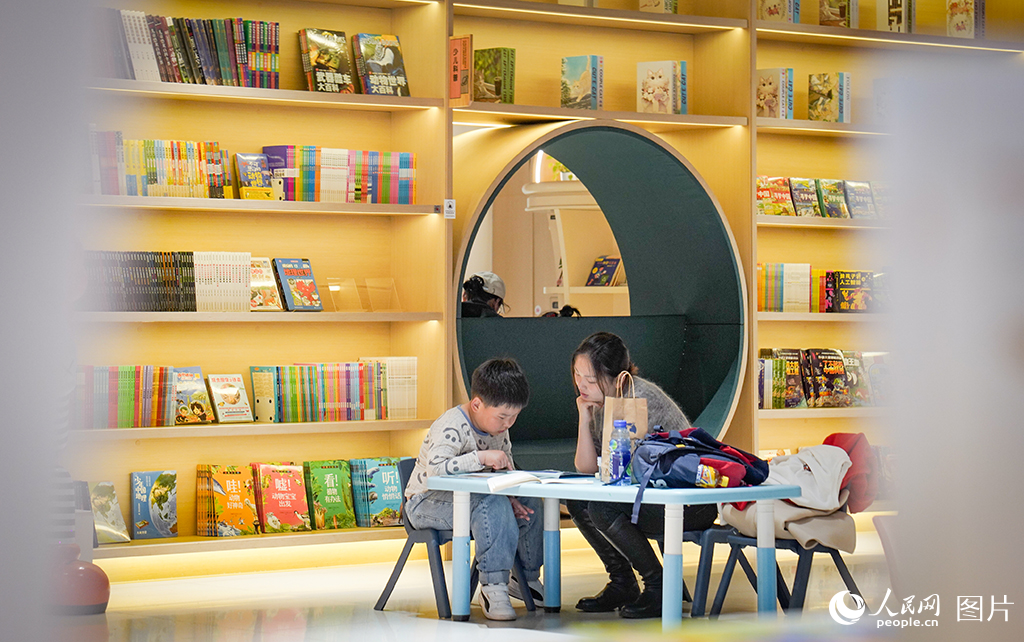 2025年5月3日，在黑龍江省哈爾濱市南崗新華書店內(nèi)，家長帶著孩子暢享閱讀的美好時(shí)光。人民網(wǎng)記者 蘇靖剛攝